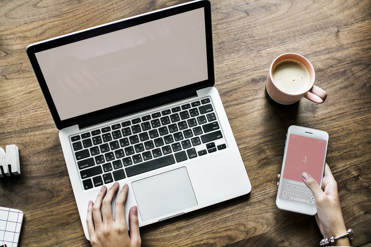 aerial of laptop, phone, and coffee